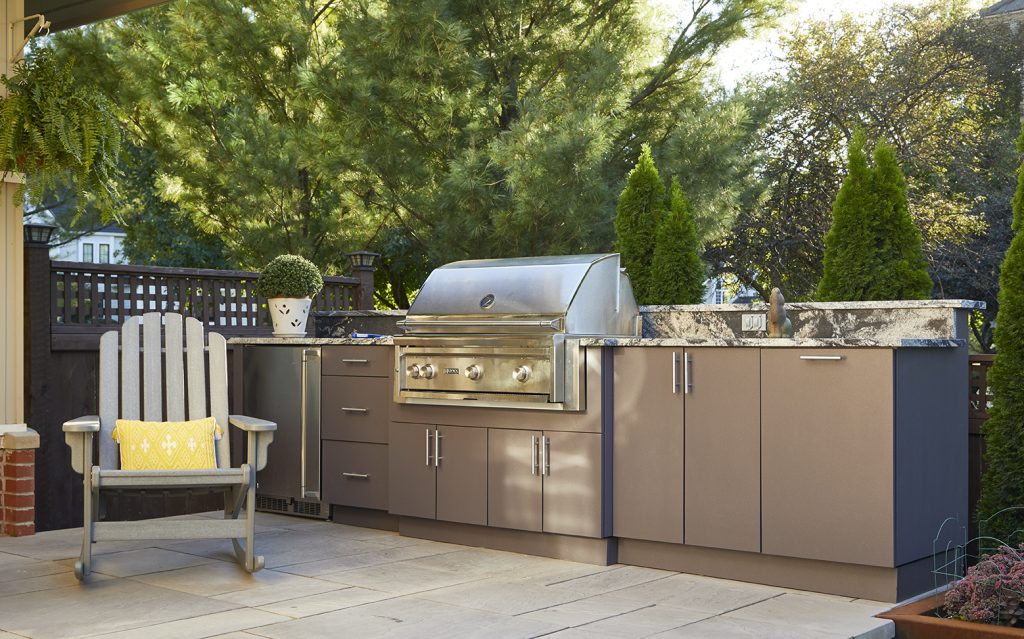 An Outdoor Kitchen landscape design by Ted Lare Design Build features a beautifully integrated cooking space with top-quality materials and custom design elements. The space often includes a built-in grill, counter space, cabinetry, and possibly a bar area, surrounded by carefully chosen plants, landscaping features, and functional seating areas, creating a perfect environment for cooking, dining, and entertaining outdoors. The design emphasizes both aesthetic appeal and practicality, tailored to the client's style and needs.